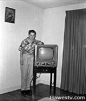 Photo: Boy and old TV set on its side